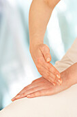 Woman massaging hand using tapping techinque