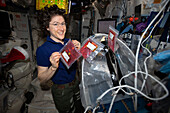NASA astronaut holding media bags