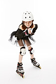 Girl in black and white tutu costume on roller skates