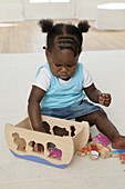 Baby girl playing with wooden toys
