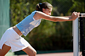 Teenage girl warming up before tennis match