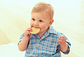 Boy eating a biscuit