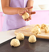 Girl making cheese bread rolls
