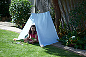 Girl under simple tent shelter