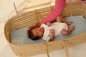 Baby boy in Moses basket