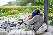 Affectionate couple cuddling on luxury patio