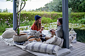 Couple enjoying wine on luxury patio cushions