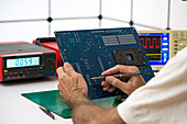 Technician repairing a motherboard