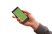 Person holding a mobile phone with a green screen
