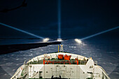 Icebreaker ship cruising at night in the polar seas