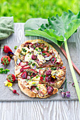 Pizza with rhubarb, radishes, brie cheese, strawberries and poppy seeds