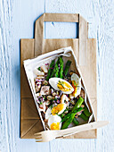 Tuna salad lunch box with asparagus and boiled eggs