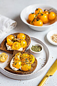 Toasts with yellow cherry tomatoes