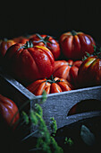Beefsteak tomatoes in a rustic wooden box