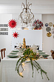 Festive dining table with Christmas decorations and fir branches