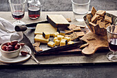 Cheese with rosemary crackers, olives, and red wine