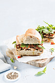 Baguette sandwich with sardines, olive tapenade and ratatouille