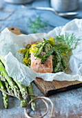 Salmon with green asparagus in a parchment parcel