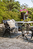 Seat with ornamented bench in sunny garden