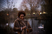 Happy young woman in park at dusk
