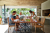 Family working and playing at dining table