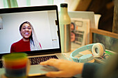 Smiling businesswoman video chatting with colleague