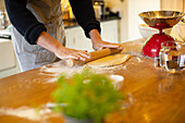 Man rolling out dough in kitchen