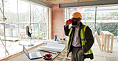 Architect drinking coffee at construction site
