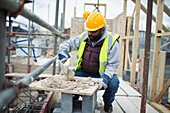 Construction worker mixing concrete at construction site