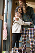 Happy young couple in pyjamas hugging