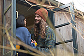 Happy young couple talking in cabin window