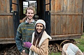 Happy young couple outside tiny cabin rental