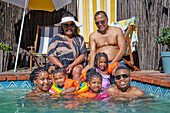 Happy multigenerational family at summer swimming pool