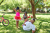 Father and daughters in backyard