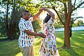 Happy couple dancing in backyard