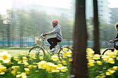 Young woman riding bicycle in sunny park