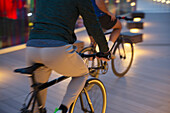 Man riding bicycle on path at night