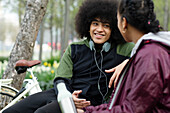 Young man talking to friend in park