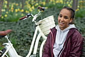 Young woman with bicycle in park