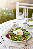 Asparagus salad with a runny poached egg