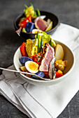 Potato pepper salad with quail eggs and grilled tuna