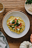 Pumpkin risotto with goat cheese and bacon chips