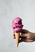 Ice cream cone with blackberry ice cream