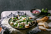 Salad with tattered mozzarella buffalo, olives and greens