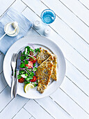 Peppered pork schnitzel with watercress salad