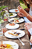 Set table with summery outdoor barbecue dishes