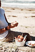 Eating cooked seafood on the beach