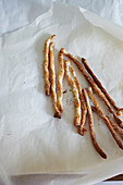 Freshly baked cheese sticks on baking paper