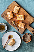 Griechischer Feta-Käse gebacken in Blätterteig mit Honigsauce und geröstetem Sesam