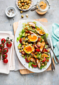 Caesar salad with chicken, tomatoes, boiled eggs and croutons